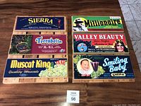 Seven folk wall art panels made from wine grape crates, arranged on floor showing all label designs clearly.