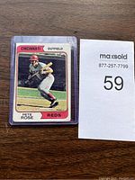 Front view of the 1974 Pete Rose baseball card in protective sleeve showing Pete Rose in batting stance for the Cincinnati Reds.