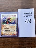 Front view of 2003 Hitmonchan ex Pokémon card with visible holographic artwork and text details.