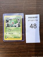 2004 Bulbasaur Pokemon card in protective plastic sleeve with MaxSold lot tag