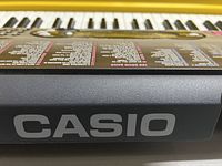 Close-up photo of Casio keyboard showing the brand name on the side and part of the control panel.