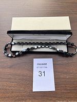 Full necklace laid out in a box showing the overall length and presentation.