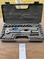 Full view of socket wrench set in black plastic case showing all tools and sockets arranged neatly.