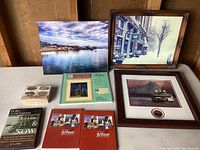 Full lot overview with framed photos, DVDs, atlas, and stamps on display