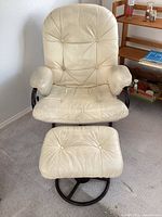 Front view of vinyl lounge chair with ottoman on carpet