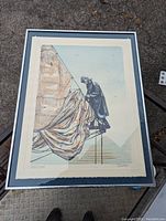 Framed artist proof print 'Sailor Rigging A Sail' showing the full artwork and frame on an outdoor concrete surface.