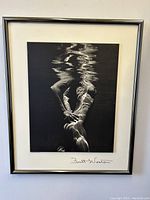 Frontal view of framed black and white underwater nude print with Brett Weston signature