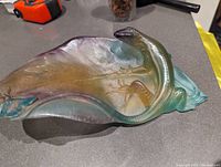 Angled top view on countertop showing full leaf form and lizard detail.