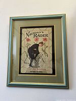 Frontal view of the framed vintage Naumann's Bicycle print against a wall showing full artwork and frame.