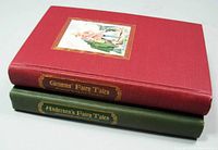 Two hardcover books stacked: Grimms' Fairy Tales (red) on top, Andersen's Fairy Tales (green) beneath