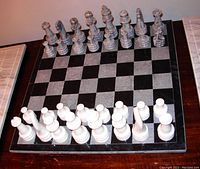 Marble chess set complete on the board with all pieces arranged for display