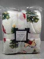 Packaged Charter Club Cozy Plush Throw folded and tied with white ribbon inside a clear plastic bag showing dog and Christmas tree pattern.