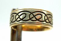 Close-up of ring band showing blackened Celtic knot pattern