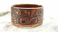 Front and side view of vintage copper ring with detailed Haida Eagle clan motif showing wear and oxidation.