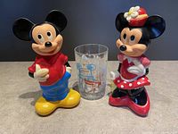 Front view of Mickey Mouse and Minnie Mouse figurines with DisneyWorld 25th Anniversary collectors glass centered.