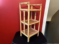 Three-quarter angled view showing bamboo frame and three wooden shelves