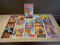15 Scooby-Doo! Where Are You? comic books arranged in rows with one comic propped up on a stand to show the cover.