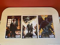Front view of three comic books issues #2, #3, and #4 from The X Files series, each boarded and bagged.