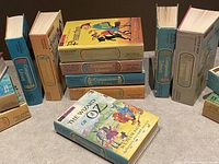 Books stacked and arranged showing their spine labels with 'Companion Library' branding and colorful illustrated dust jackets for books like Pinocchio and The Wizard of Oz.