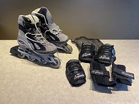 Full lot including Tecnica roller blades, black protective knee, elbow, wrist pads branded 'Legends', and a black mesh bag
