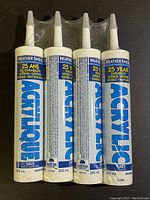 Four Weathershield Acrylic Caulking tubes lined up, showing front labels with product name, volume, and durability info.