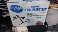 Box showing Forsite Health Deluxe Pedal Exerciser title and main features including low impact exercise, removable digital display, and exercise benefits.