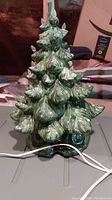 Front view of the vintage green ceramic lighted Christmas tree with clear bulbs and attached power cord