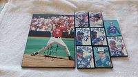 Overview of nine vintage Toronto Blue Jays autographed wood plaques including one larger pitcher photo and eight smaller autographed cards.