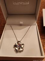 Flower-shaped silver pendant necklace with multicolor stones displayed in Effy jewelry box.