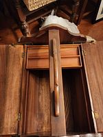 Top view of sewing table with hinged lid open revealing interior compartments