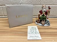 Full view of the Lenox Nature Santa figurine with original box and collector's leaflet.