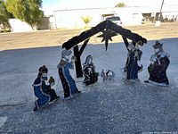 Full view of stable and all figures arranged in a row on pavement