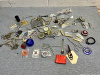 Overview image showing entire assortment of various small items on grey fabric.