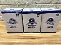 Three unopened boxes of Empress brand 5.25 inch black plastic stirrers, each box labeled for 1000 stirrers.