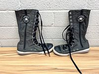 Pair of Chuck Taylor All Star extra large junior high top Converse sneakers side view showing grey textile uppers, black laces and white midsoles with black stripe, side zipper and All Star patch.