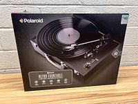 Front view of boxed Polaroid Retro Turntable showing image of the turntable and product name.