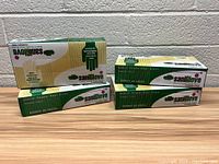 Four boxes of SaniGlove vinyl gloves arranged to show branding and packaging details