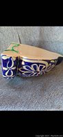 Side view of the ceramic planter pot showing blue and white floral design with handle