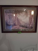 Framed picture of terrace outdoor scene with mountains in background, hung on wall.