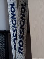 Close-up image of white Rossignol kids cross country skis with blue branding