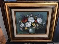 Front view of the framed floral oil painting on canvas with a bouquet in a vase.
