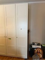 Front view of closed cabinet with three door panels and knobs