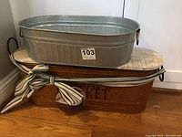 Copper bucket with lid and decorative bow underneath aluminum bucket