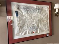 Full front view of framed indenture showing mat board and frame