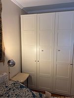 Front view of closed cabinet showing three shaker-style doors and knobs