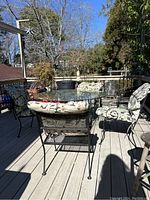 Full set of metal table and chairs with cushions on deck