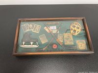 Front view of vintage hockey themed shadow box with various miniature hockey items inside
