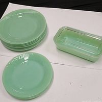 Overall view of jadeite luncheon plates, salad plates, and covered dish with glass lid
