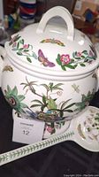 Side view of the tureen showing passionflower, butterflies, and floral motifs.
