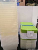 Stack of translucent plastic boxes without lids shown on left side